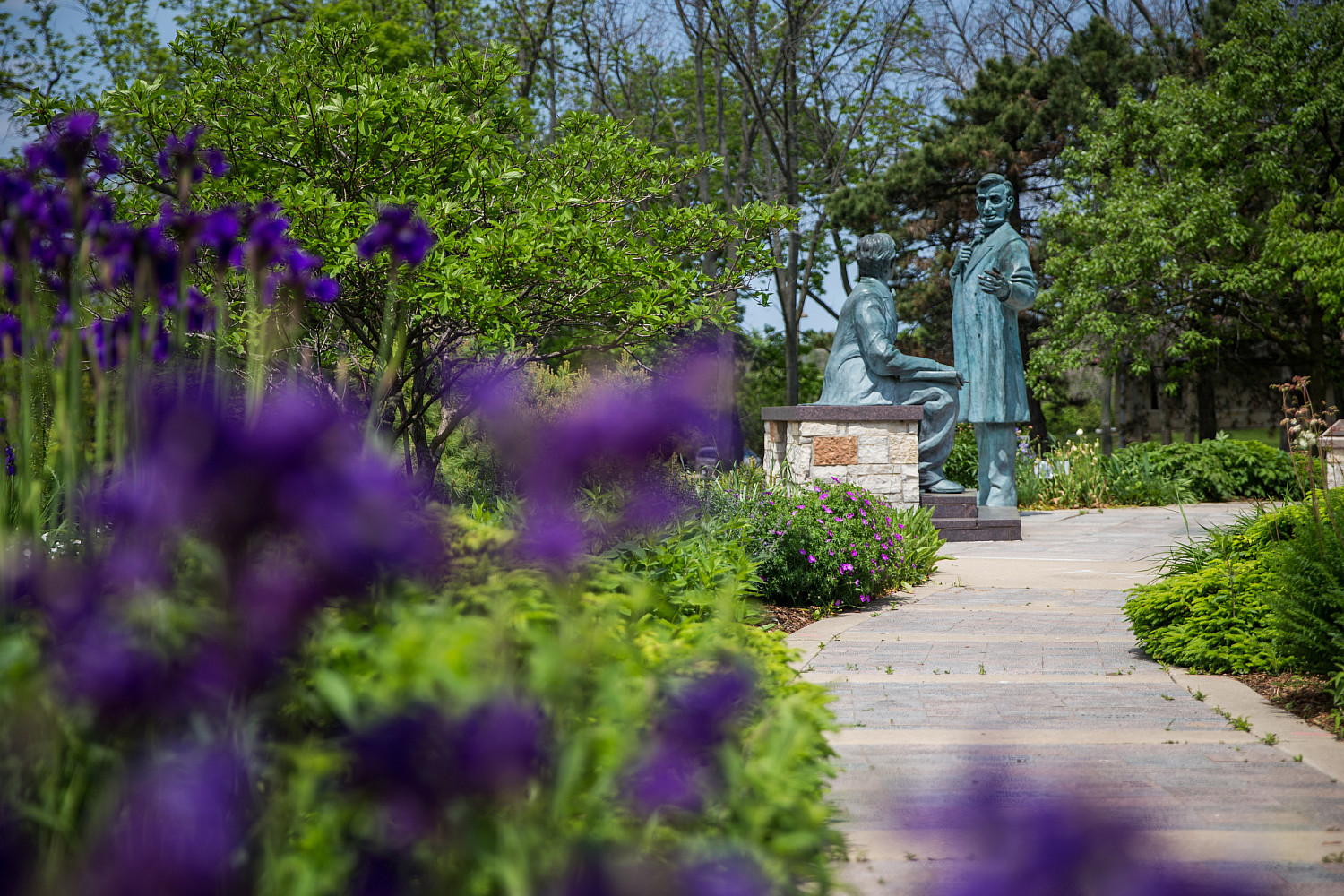 A spring look at the Learning Moment statue on Campus Drive.