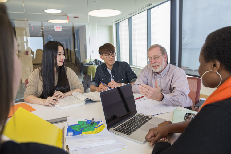 Retired Carthage College professor Edward Montanaro teaches a small class of economic students.