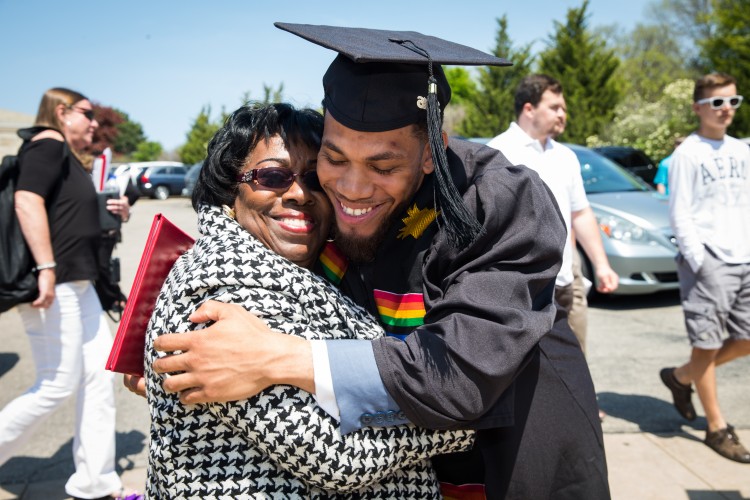 A Carthage College student hugs his mother after celebrating commencement with his fellow graduat...