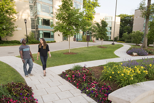 Students walk through the Oaks Circle, on the residential side of campus.