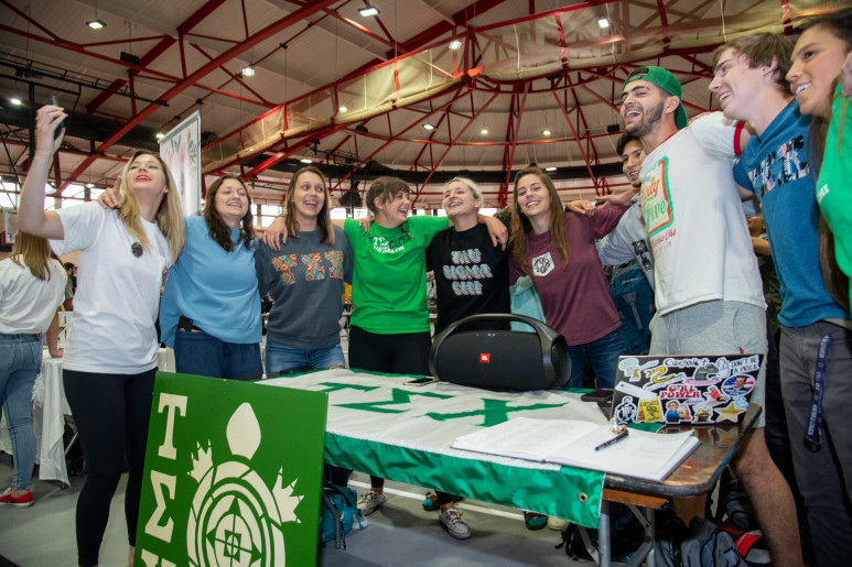 Members of a Carthage College student organization pose for a photo during an organization fair.