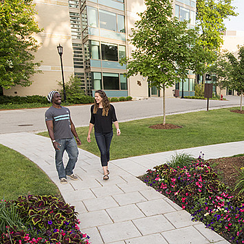 Students walk through the Oaks Circle, on the residential side of campus.