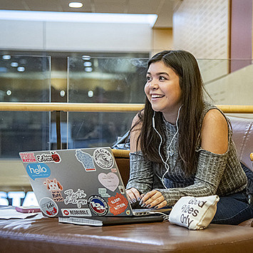 A student works on her laptop in the A. W. Clausen Center for World Business.