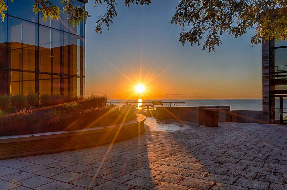 The sun's rays begin to wake up the Carthage College campus near the Hamar Patio near the Science...