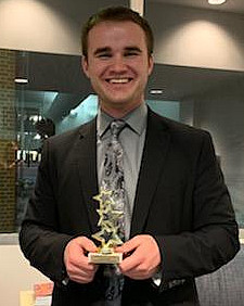 Joshua Kundert with his award from the Mock Trial tournament at Loras College in Jan. 2019. 
