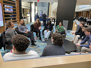 The Front office members listening to Sandy Burhans, sports and entertainment leader for ORBA.