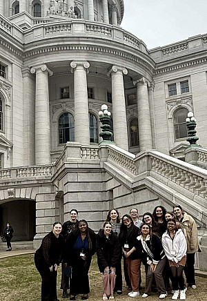 Social work students in front of the Wisconsin state capitol building. Pictured: Emma Newcomb '25, Mariah Parker '26, Clytise McGee '26, ...