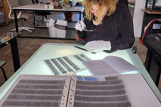 Professor Jojin Van Winkle reviews a project at a studio table