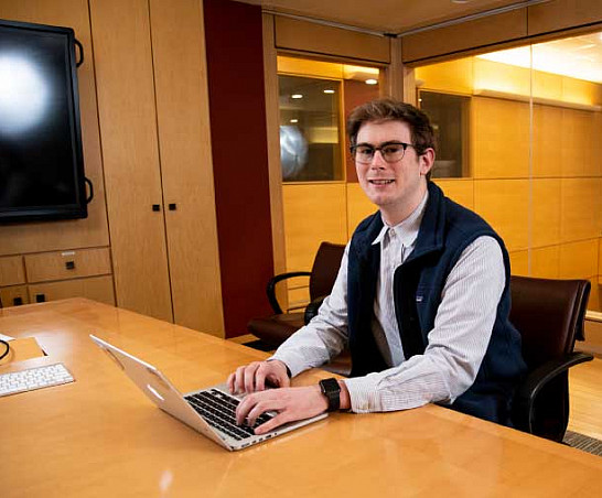 Graduate student working on a laptop.