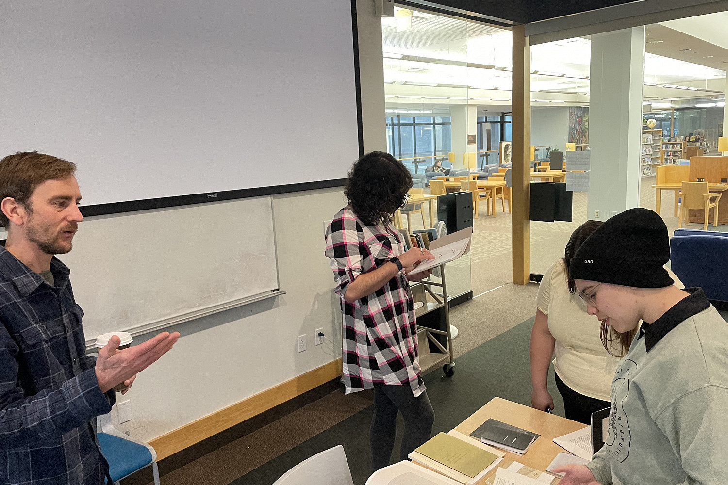 Students discussing writing and books with visiting writer Jordan Dunn during a class visit.