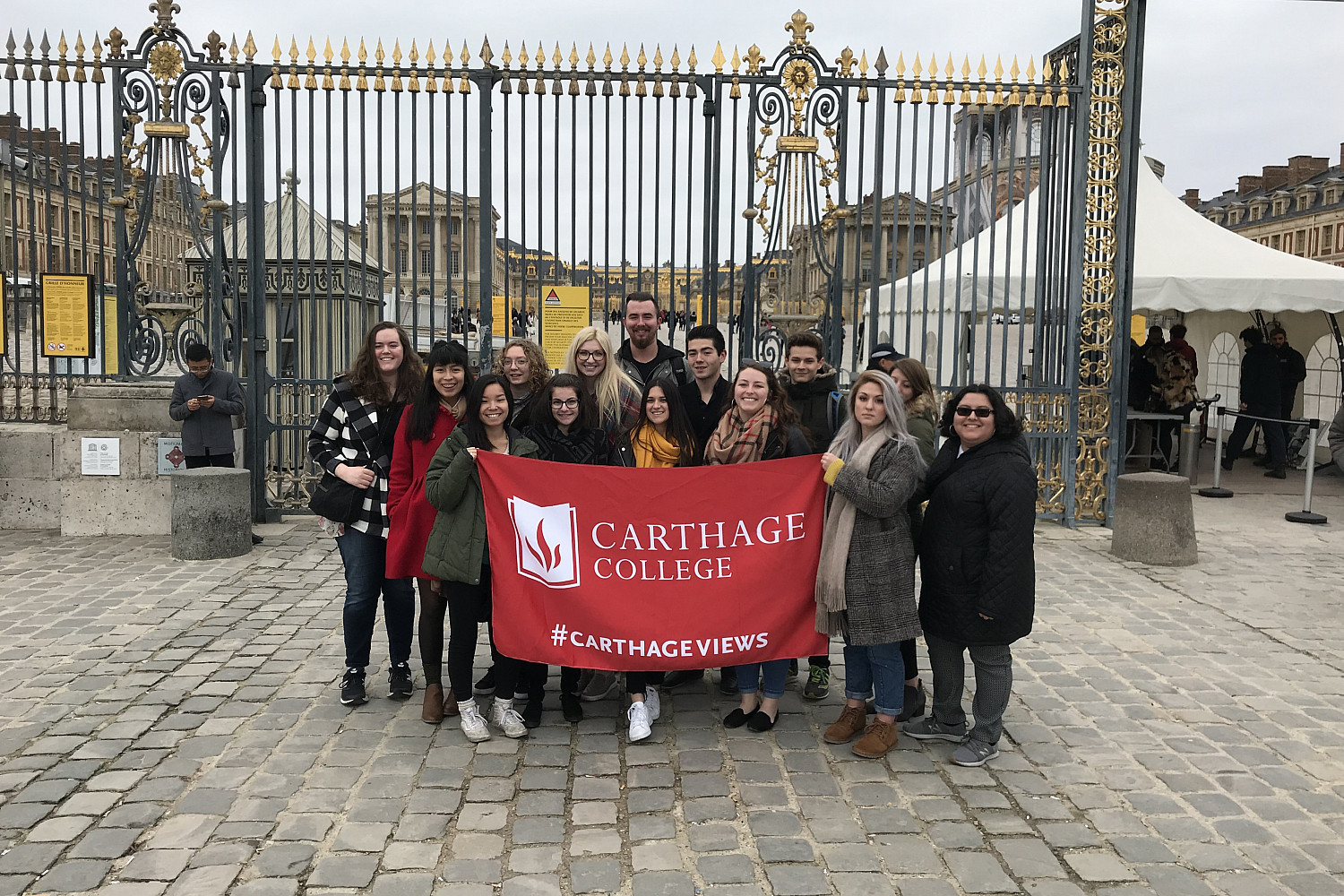 A group photo taken in front of Versailles, a palace in France.