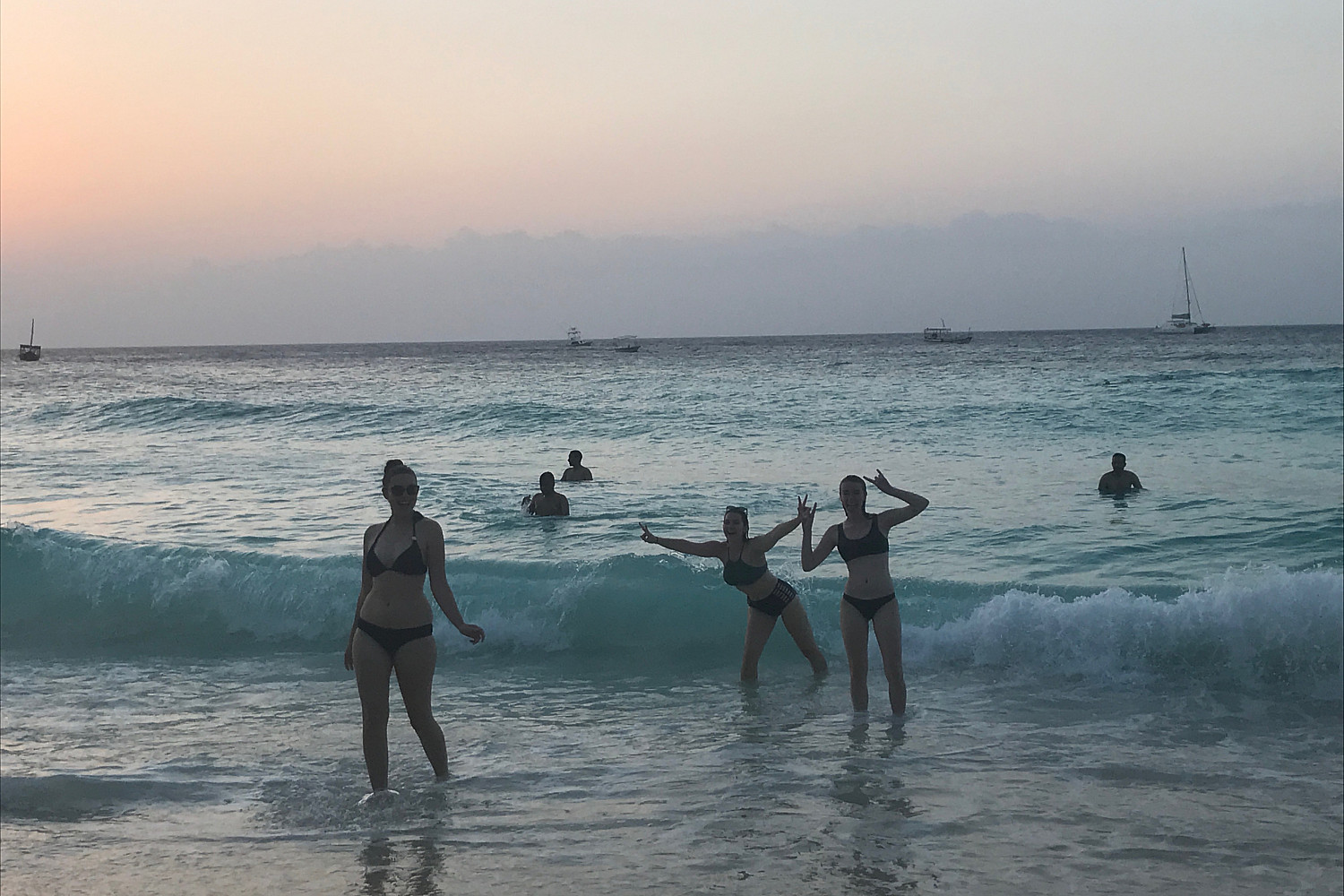 Students pose on the ocean front.