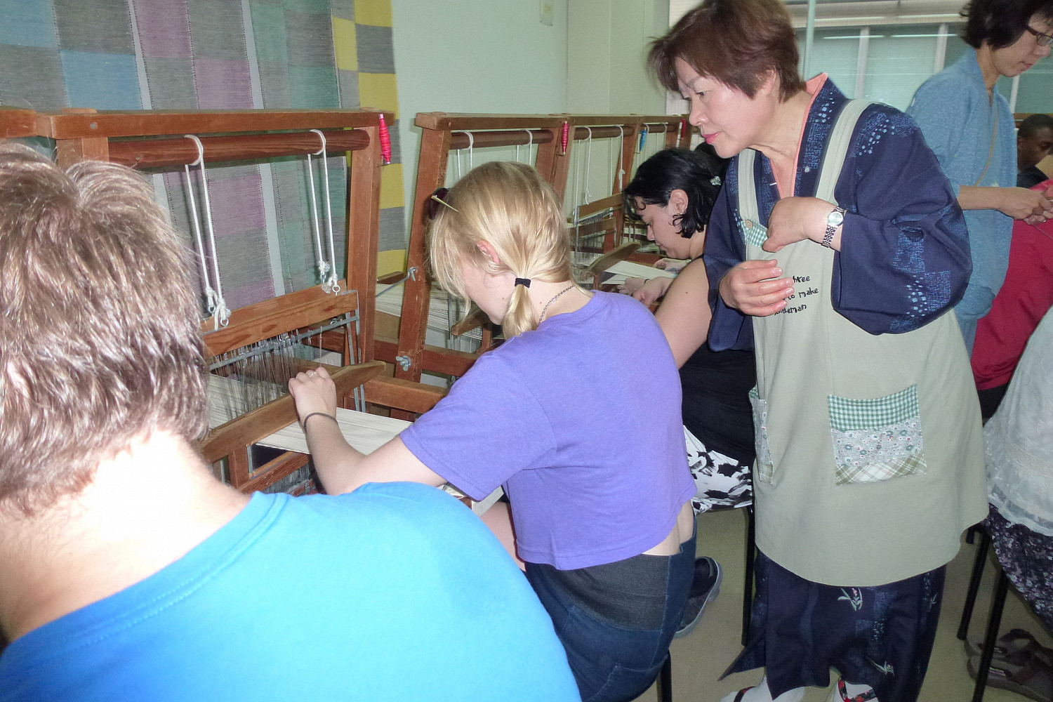 Students loom weaving.