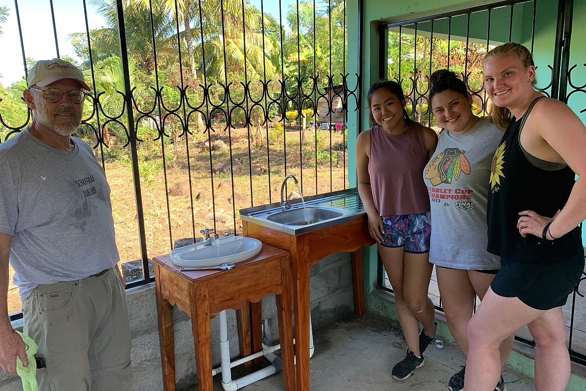 Students celebrating a completion of a water project.