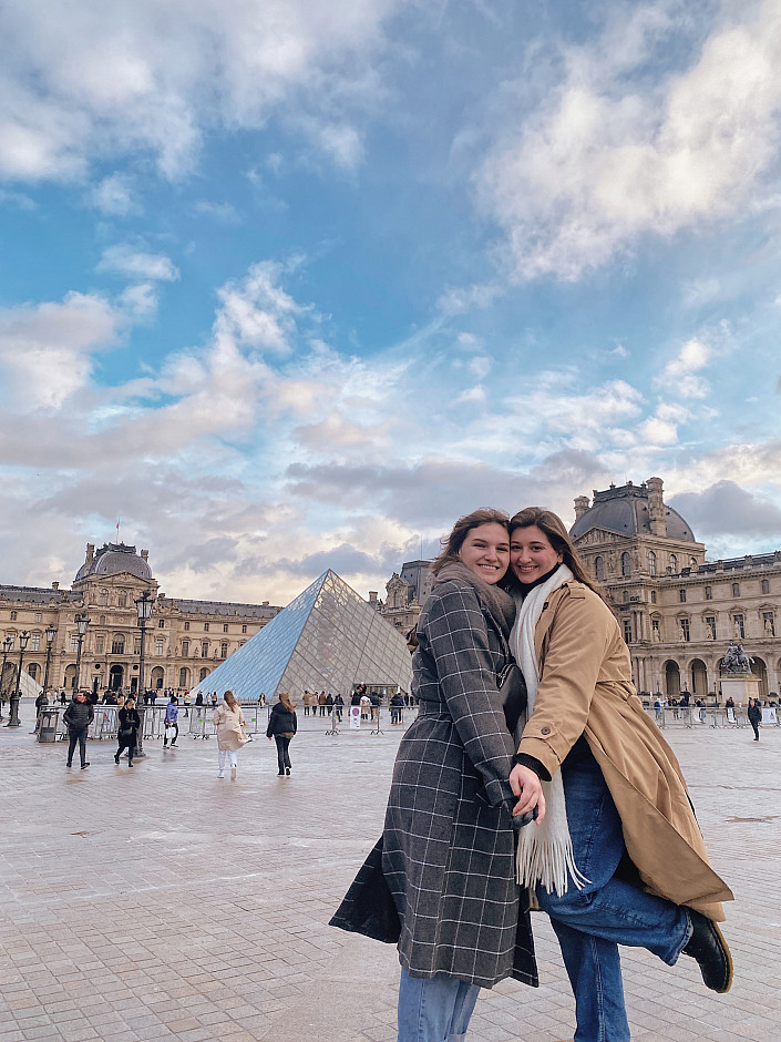 Students in the 2023 Paris study tour pose for a photo outside The Louvre.
