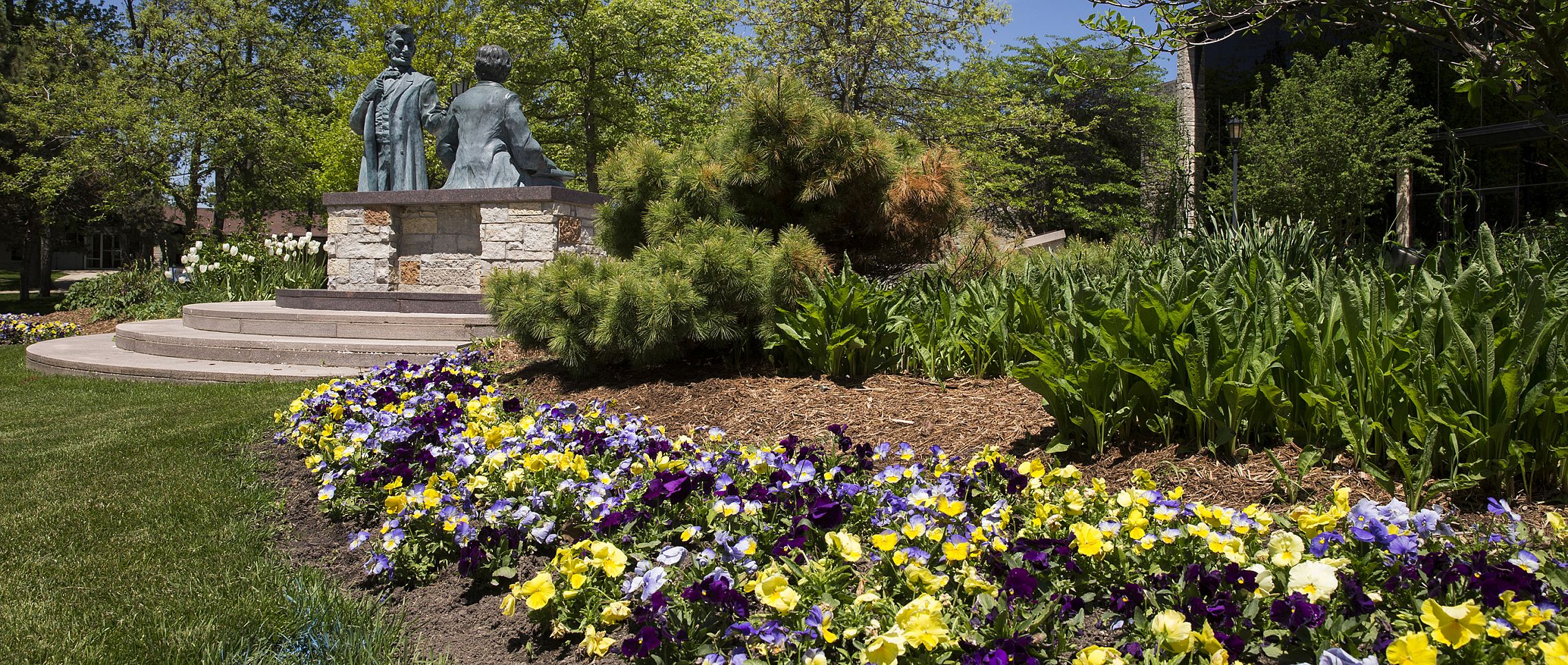 The Lincoln-Hayes statue with flowers in the spring.