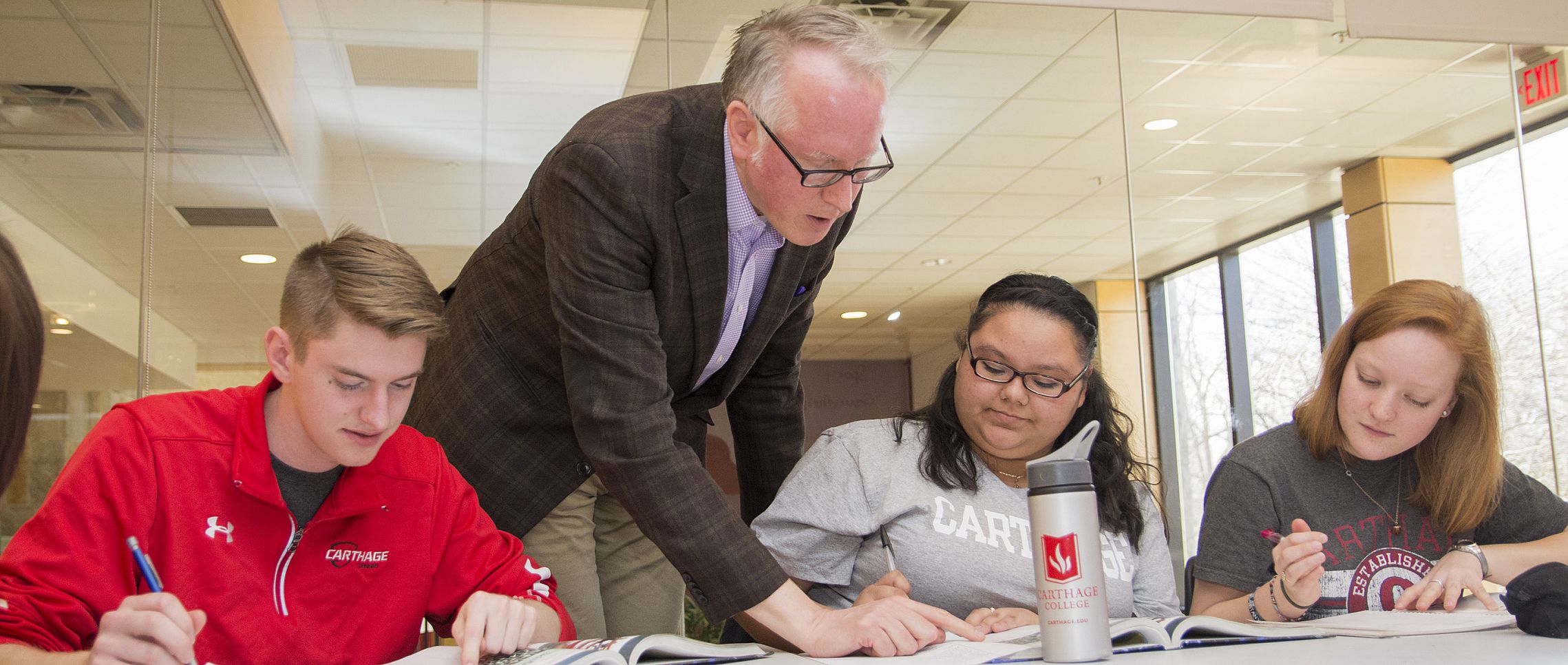 A student writing on a white board.