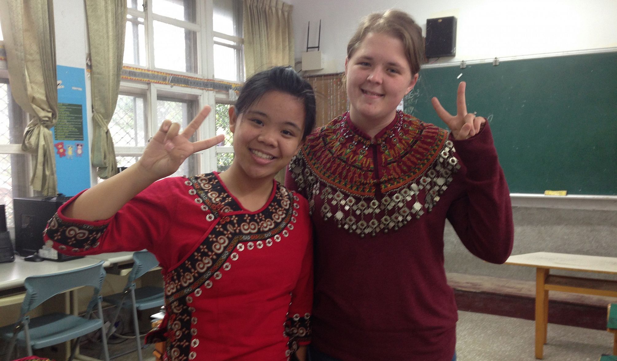 Jessie Bingaman '16 dons a traditional Paiwan collar, with her sixth-grade student Annie, in traditional clothing, as a Fulbright English...