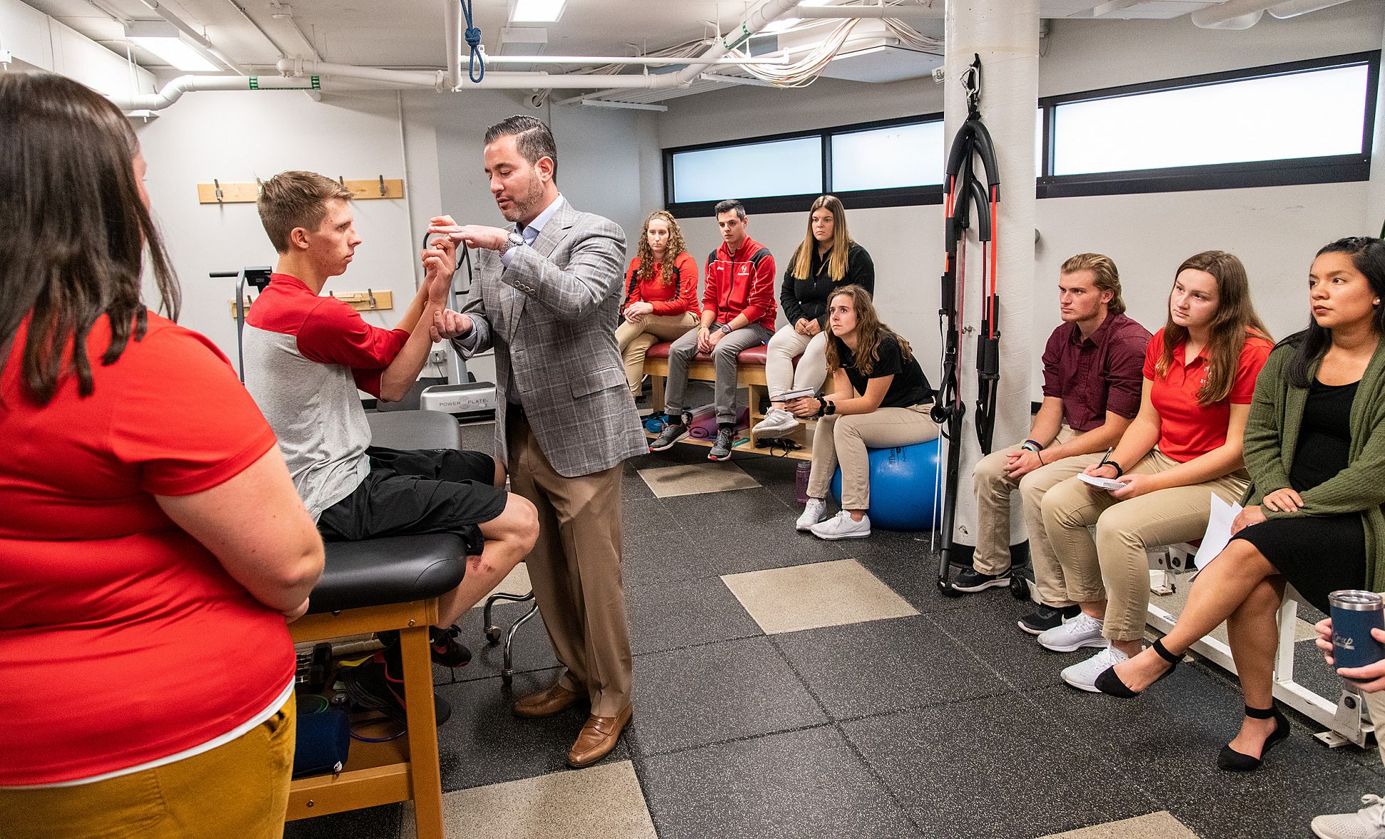Master of Athletic Training students gather for a demonstration during an athletic training class.