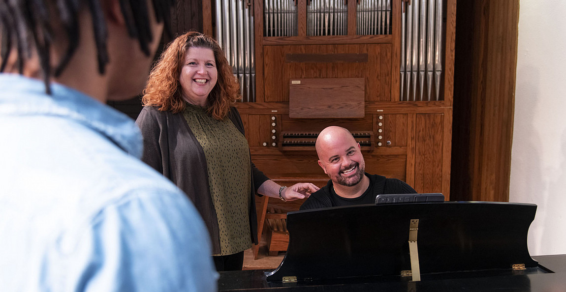 Prof. Corinne Ness and Prof. Matthew Hougland coach students during a class.