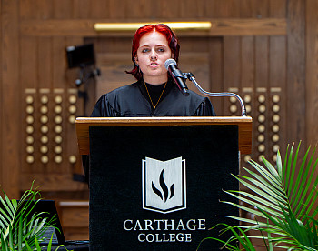 A student speaking from a podium