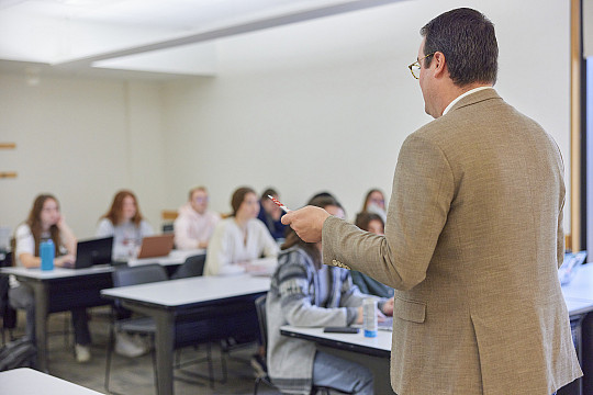 A Professor teaching in a classroom