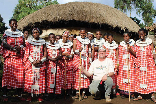 Professor Peter Dennee meets with members of a Maasai women's group to discuss and record their music.
