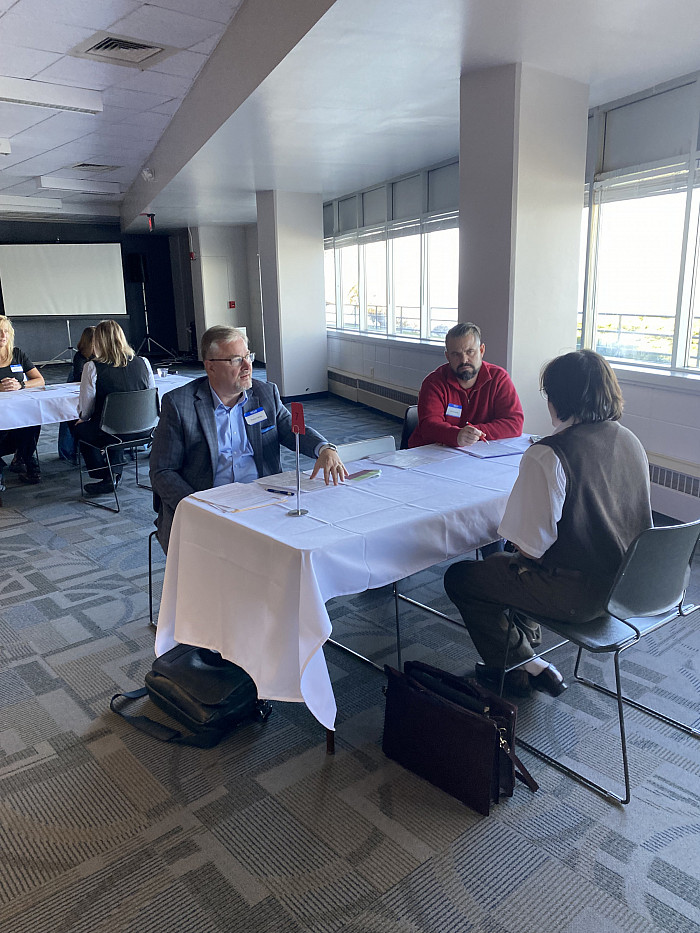 Two community members hold a mock interview for a Carthage education student.