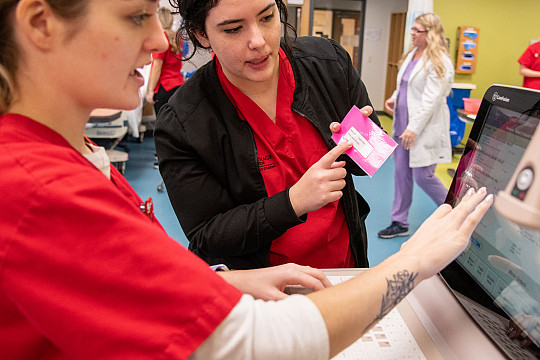 Carthage nursing majors practicing with laboratory equipment.