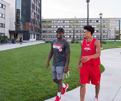 Students chat as they walk around campus.