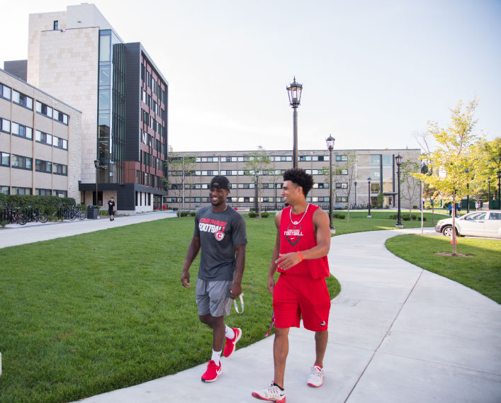 Students chat as they walk around campus.